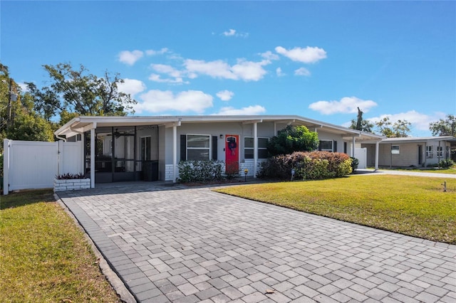 view of front of house with a front lawn and a carport