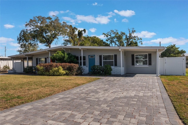 single story home with a front yard and a carport