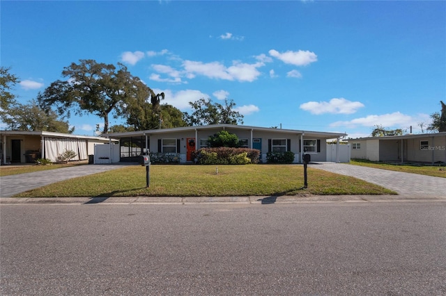 single story home with a carport and a front lawn