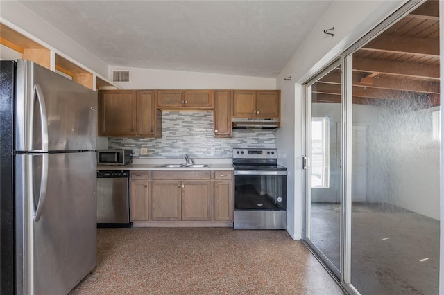 kitchen featuring appliances with stainless steel finishes, sink, and backsplash