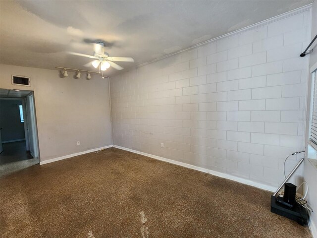 unfurnished room with track lighting and ceiling fan