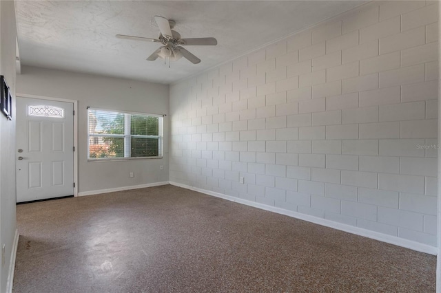 entryway featuring ceiling fan and a textured ceiling