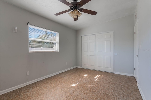 unfurnished bedroom with ceiling fan and a closet