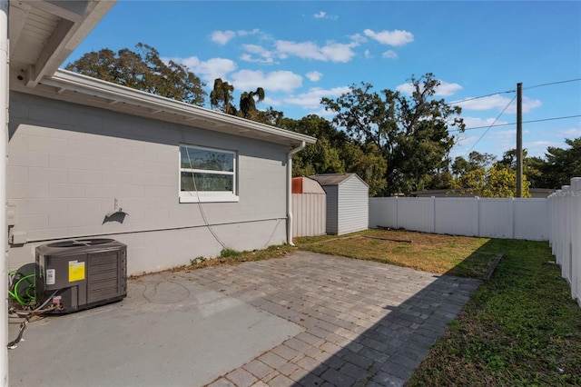 view of patio / terrace featuring central AC and a storage unit