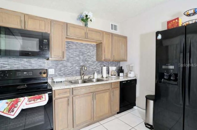 kitchen with sink, light tile patterned floors, light brown cabinets, decorative backsplash, and black appliances