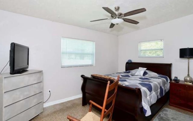 bedroom featuring ceiling fan and light colored carpet