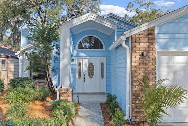 view of exterior entry featuring a garage