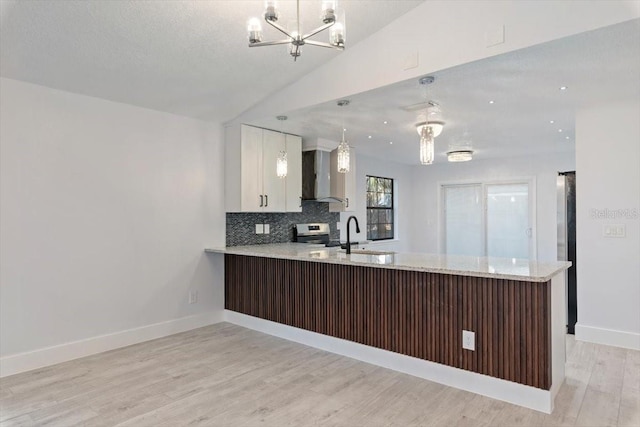 kitchen with sink, decorative light fixtures, and kitchen peninsula