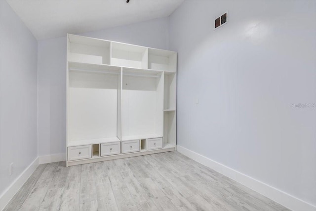 mudroom with lofted ceiling and light wood-type flooring