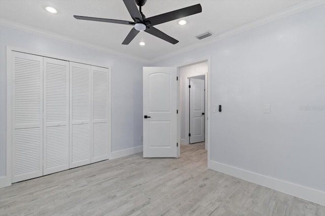 unfurnished bedroom with ceiling fan, a closet, ornamental molding, and light hardwood / wood-style flooring