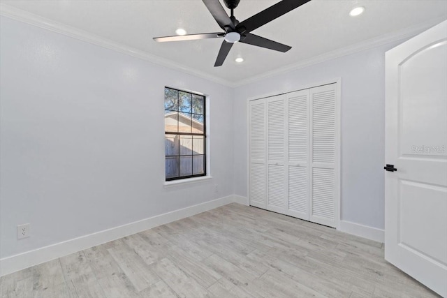 unfurnished bedroom featuring ceiling fan, ornamental molding, a closet, and light wood-type flooring