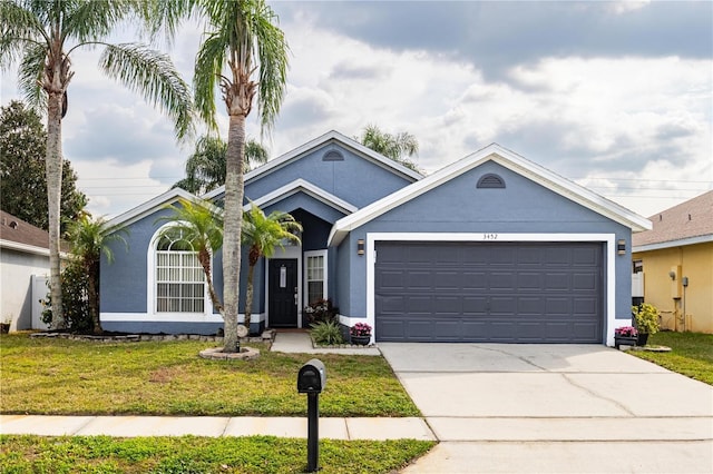 view of front of property with a garage and a front yard