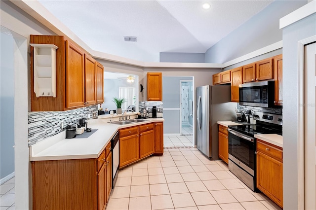 kitchen featuring sink, light tile patterned floors, ceiling fan, backsplash, and stainless steel appliances