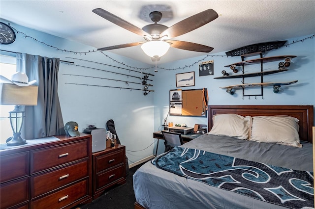 bedroom with ceiling fan and a textured ceiling