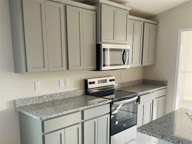 kitchen with appliances with stainless steel finishes and gray cabinetry