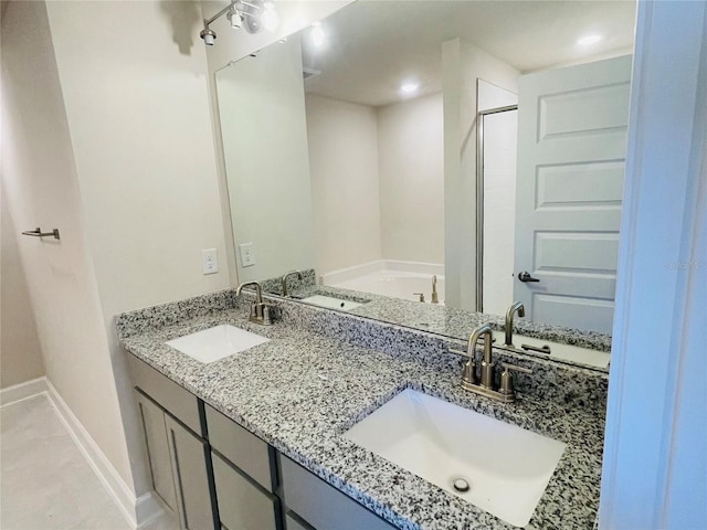 bathroom with vanity and a washtub