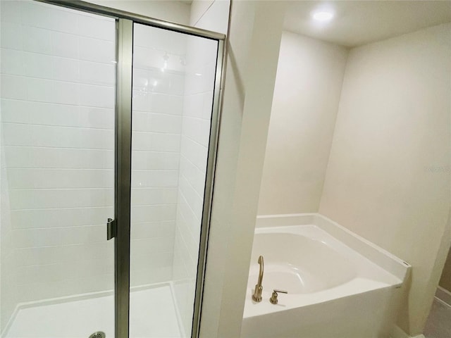 bathroom featuring plus walk in shower