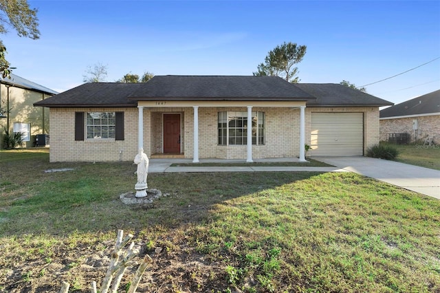 single story home with a garage, a front yard, and covered porch