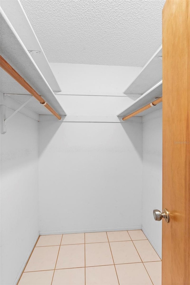 spacious closet with light tile patterned floors