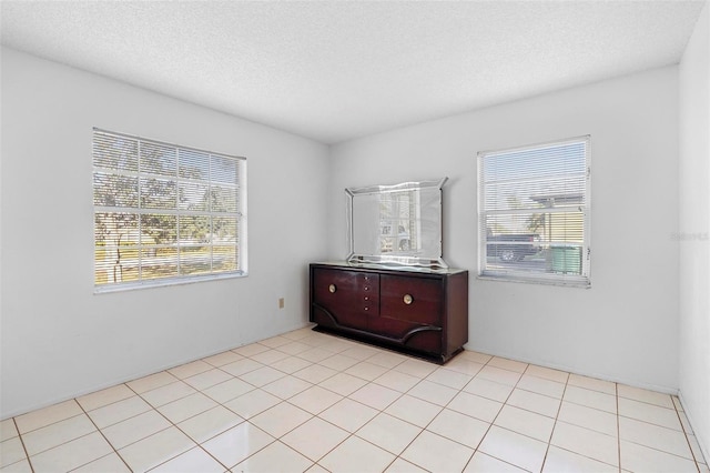 spare room featuring a wealth of natural light and a textured ceiling