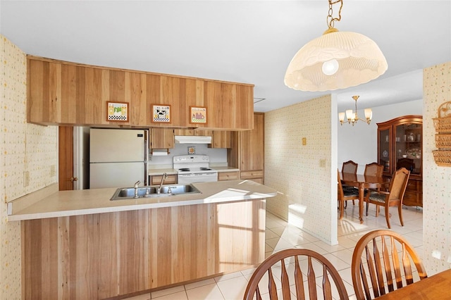 kitchen with sink, white appliances, light tile patterned floors, an inviting chandelier, and kitchen peninsula