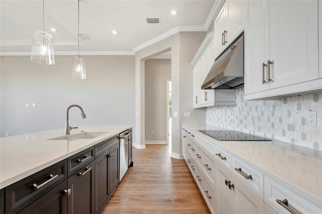 kitchen with sink, white cabinetry, black electric cooktop, dishwasher, and pendant lighting