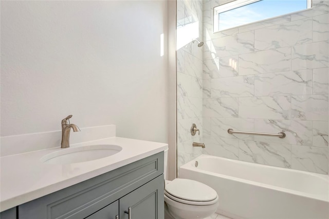 full bathroom with tiled shower / bath, vanity, and toilet