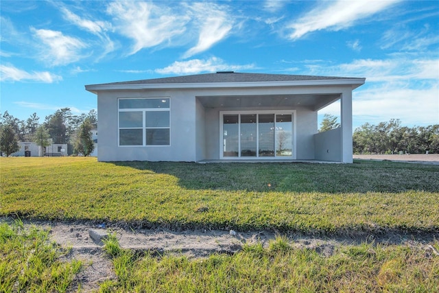 rear view of house with a lawn