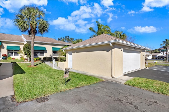 view of home's exterior with a garage and a lawn