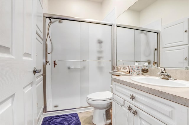 bathroom with vanity, toilet, and walk in shower