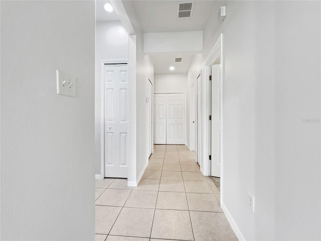 corridor featuring light tile patterned floors