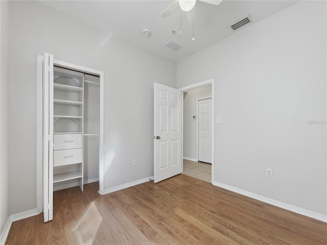 unfurnished bedroom featuring a closet, ceiling fan, and light wood-type flooring