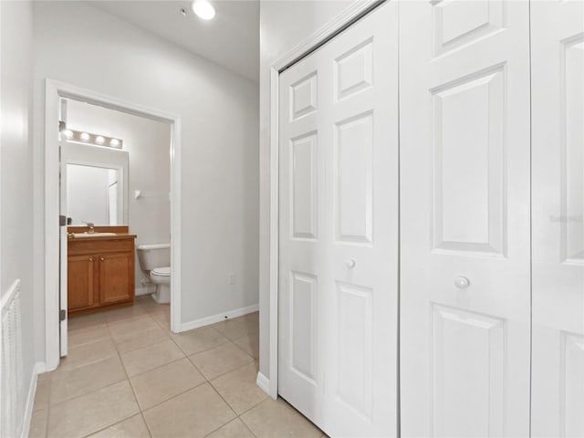 hallway with sink and light tile patterned floors