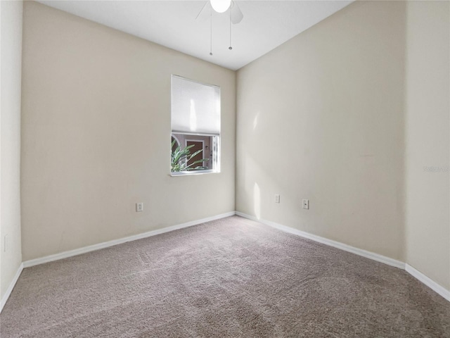 carpeted spare room featuring ceiling fan