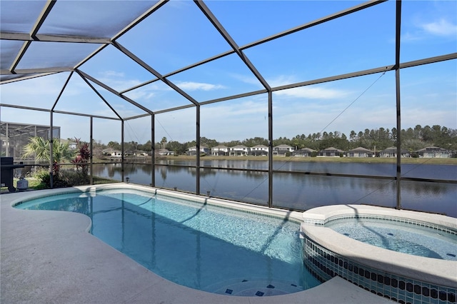 view of pool featuring an in ground hot tub, a water view, and glass enclosure