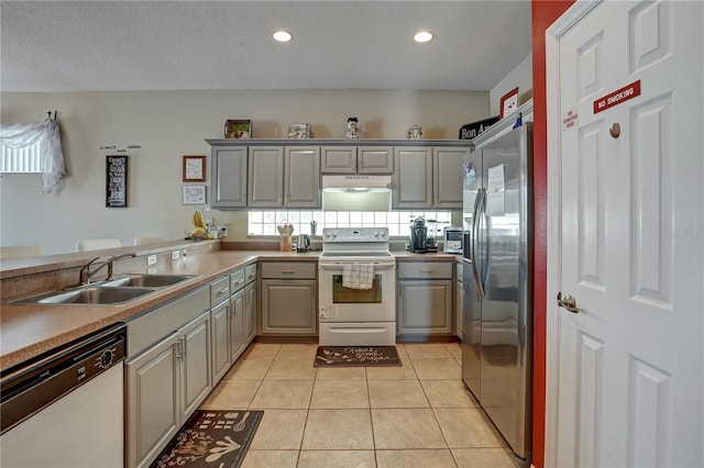 kitchen featuring white electric range, stainless steel fridge, dishwashing machine, and gray cabinets