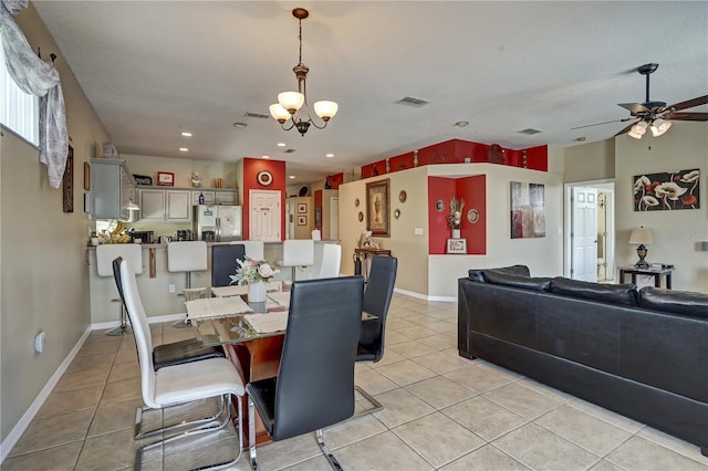 tiled dining area featuring ceiling fan with notable chandelier