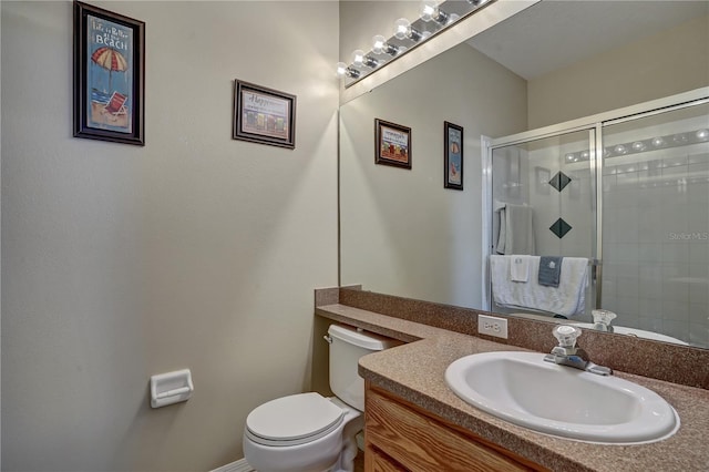 bathroom with vanity, toilet, and an enclosed shower