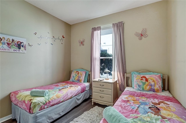 bedroom with dark hardwood / wood-style floors