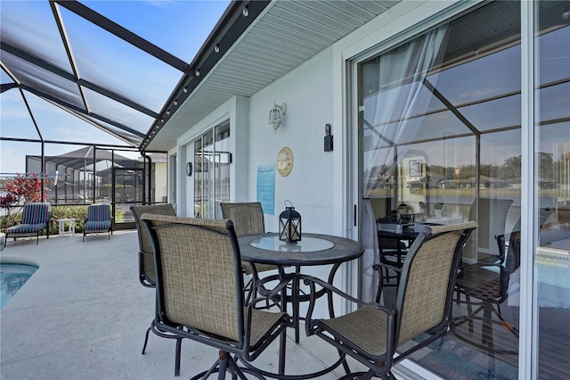 view of patio featuring glass enclosure