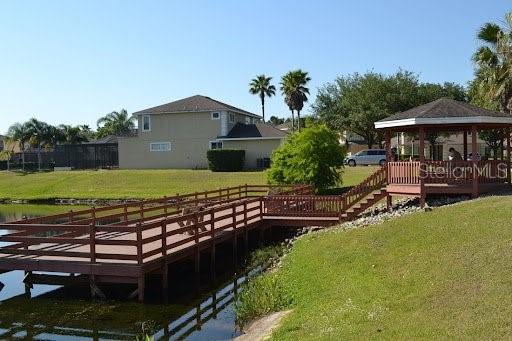 view of dock featuring a gazebo and a lawn