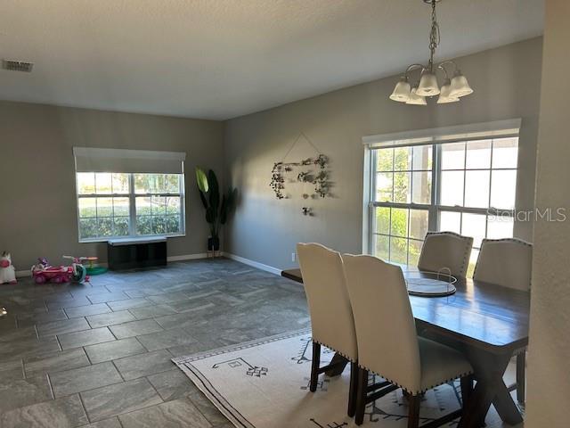 dining space with an inviting chandelier