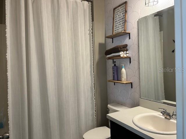 bathroom featuring vanity and toilet