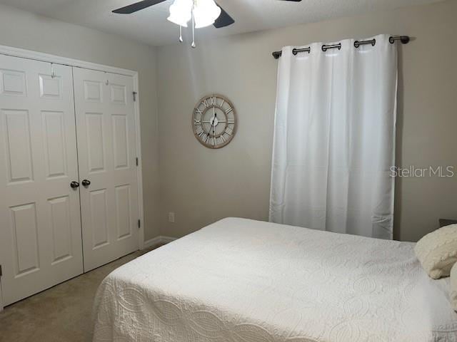 carpeted bedroom with a closet and ceiling fan