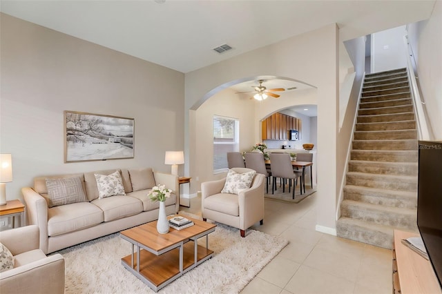 living room featuring light tile patterned floors and ceiling fan