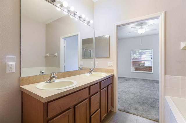 bathroom featuring vanity, tiled tub, tile patterned floors, and ceiling fan