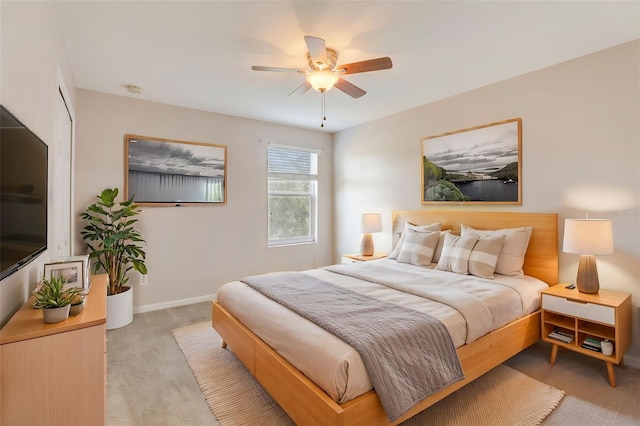 bedroom featuring light colored carpet and ceiling fan