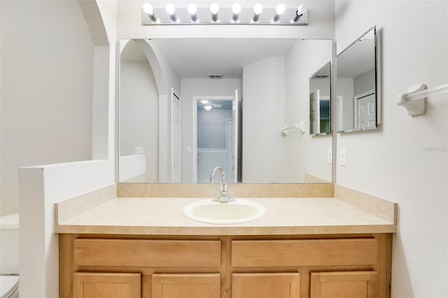 bathroom featuring vanity and toilet