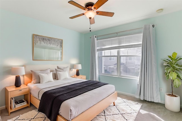 bedroom featuring ceiling fan and light carpet