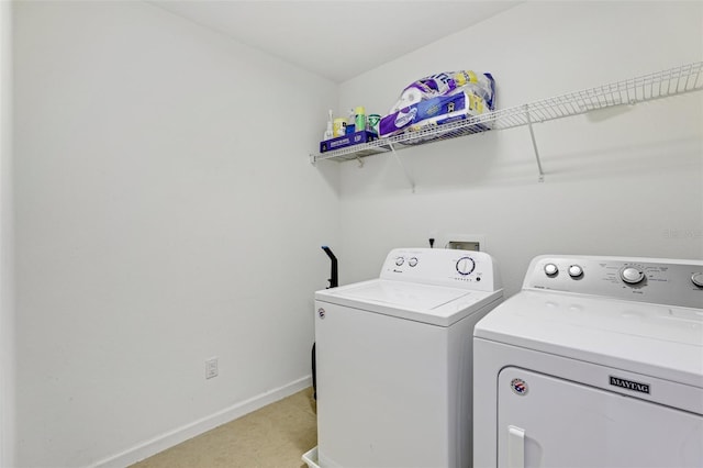 laundry room with separate washer and dryer and light carpet